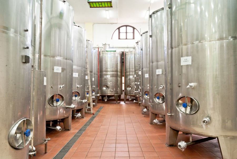 two rows of lying aluminum wine storage tanks at 'Ktima Toplou' plant
